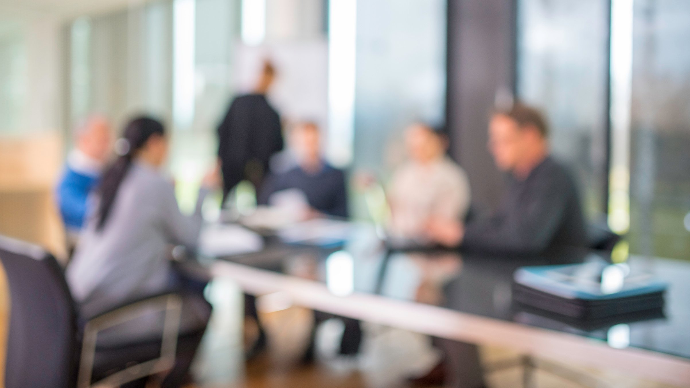 Defocused people at board meeting